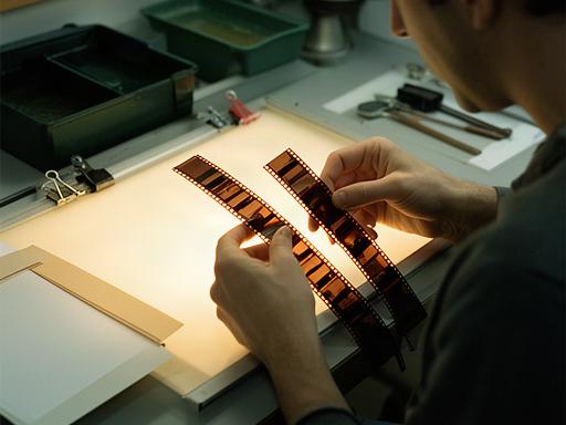 Ane revisando tiras de película en el laboratorio de revelado de P.S.G. Fotografía